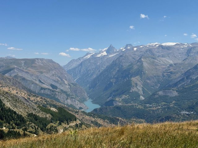 Une vue sur le lac du Chambon, la Meije et le col du Lautaret depuis le sommet des Sûres